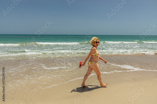 Wallpaper Mural attractive senior woman at the beautiful sandy beach in bikini Torontodigital.ca