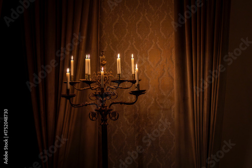 Картината върху платно Lighted candles on floor standing candelabra in large room