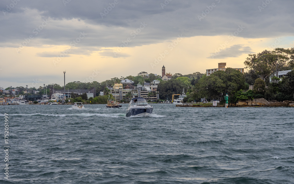 Obraz premium Residential Houses and apartment buildings on Parramatta River Sydney Harbour on a warm spring cloudy overcast day in Sydney NSW Australia 