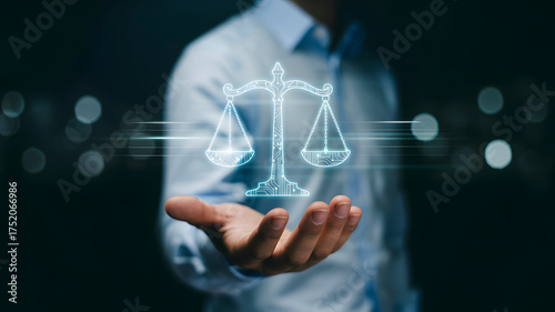 Man holding glowing digital scales of justice symbolizing legal technology innovation and fair judgment in modern business solutions