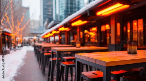 Snowy bar scene, A cozy outdoor dining area with wooden tables and warm orange lights, creating an inviting atmosphere amidst a snowy setting.