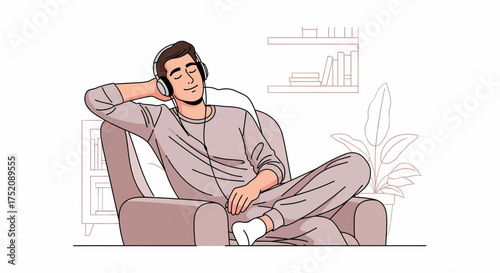 Young Man Relaxing In An Armchair Listening To Music With Headphones