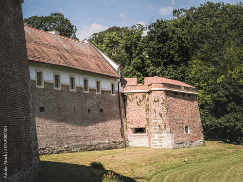 Historic red-brick defensive walls of Stari Grad Castle in Cakovec, Croatia. The medieval fortifications, surrounded by greenery, showcase the enduring architecture of the region’s heritage.