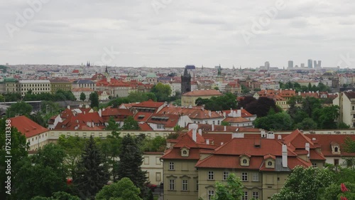 Summer cityscape of Prague with red rooftops.