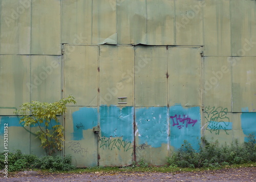 The old gates of a large sheeting-made hangar, Granite Street, Saint Petersburg, Russia, October 12, 2025
