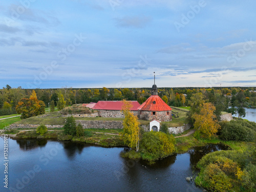 Obraz na plátně Elevated view of the circular tower and stone walls of Korela Fortress situated
