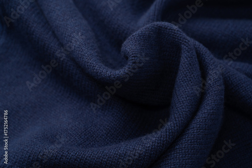 Navy blue merino wool sweater texture as background. Top view.