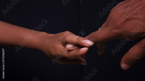 Male and female hands hand gesture on black isolated background. Imitates sex. A vulgar and exciting hand sign. Indecent hand gestures that show how sex happens. imitation penis and vagina.