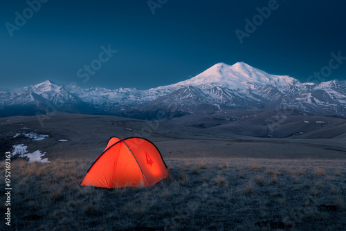 Night landscape with red bright tent mountain ridge snow-covered Mount Elbrus, Caucasus, Russia