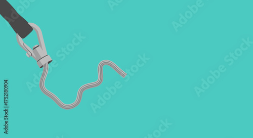 Closeup of a paint tube squeezing out a line of light pink paint.