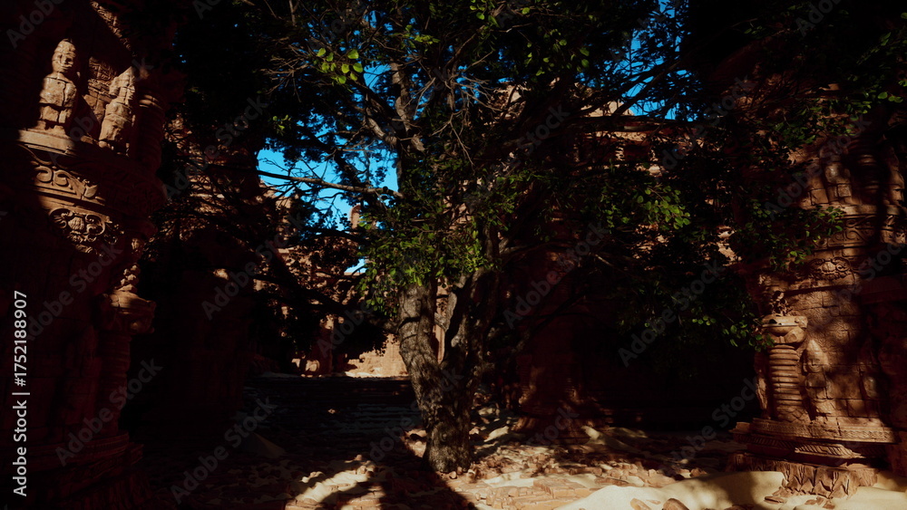Obraz premium Surrounded by towering ancient stone structures, a large tree thrives in the center, offering shade and life. Light filters through the leaves, creating a peaceful ambiance in this historical site.
