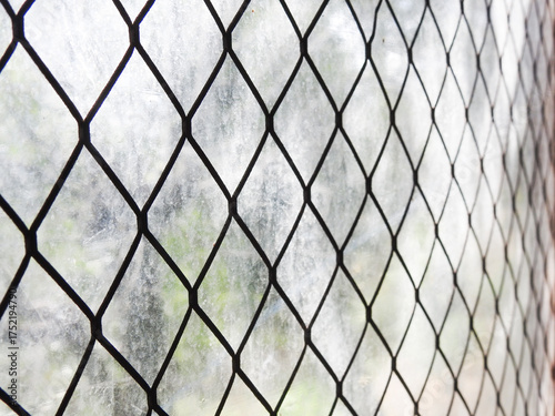 Stretched metal mesh on a blurred background