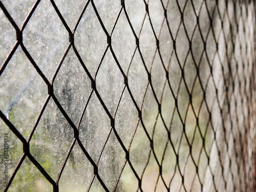 Stretched metal mesh on a blurred background