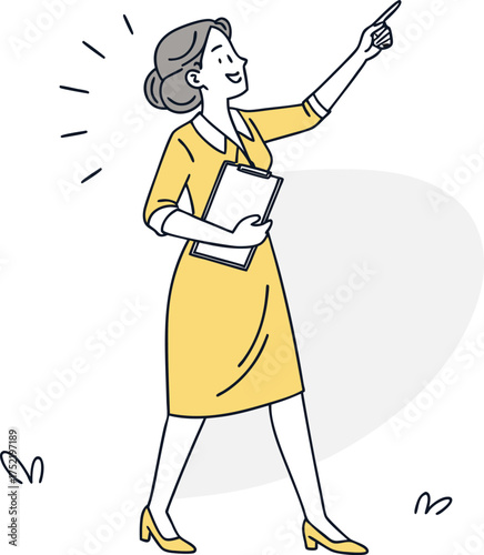 Woman in yellow dress pointing up holding clipboard