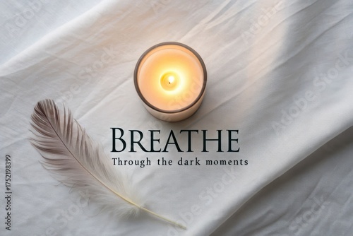 Lit candle in a glass vessel casting soft warm glow