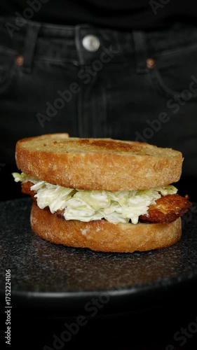 Delicious chicken Caesar sandwich rotation on plate – close up shot