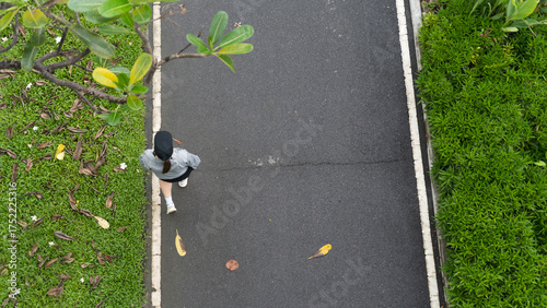 Woman walking on a path in a park, overhead view