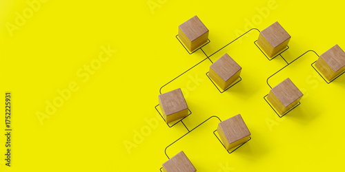 Company hierarchical organizational chart made of wooden cubes on a blue background, representing human resources management,