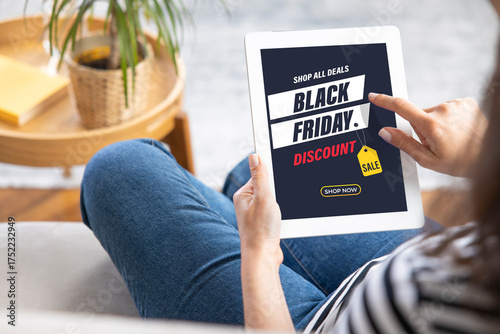 Young woman using tablet. Black Friday Sale Promo