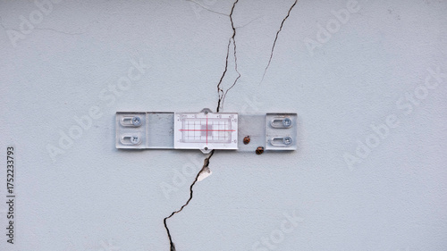 Quadro su tela Crack gauge installed on a wall to measure movement and width of a crack in building plaster
