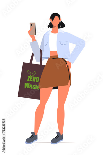 Young woman in a casual outfit standing and holding a smartphone in one hand and a tote bag with the text ZERO Waste in the other. Reusable shopping bag. Save Earth. Vector. Not AI generated.