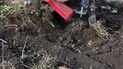 Wallpaper Mural Agricultural worker operating a tiller, breaking ground in a field, showcasing the tilling process with dynamic camera movement capturing the action flow	 Torontodigital.ca