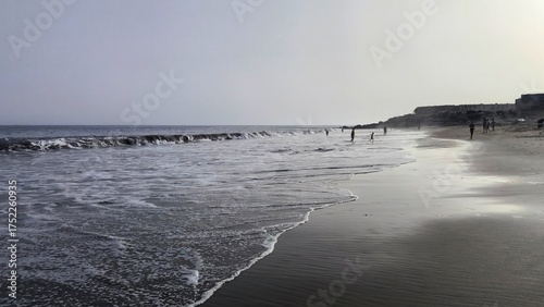 La Tejita beach in backlight with Atlantic waves and reflections on wet sand, Tenerife, Canary Islands, Spain