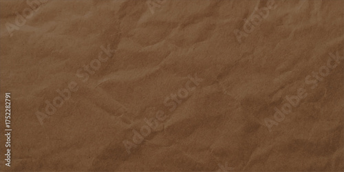 An antique brown paper texture with crumpled, rough, wrinkled, and creased vintage leather-like surface