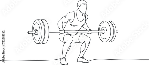 A male athlete performing a squat with a barbell in a fitness training setting.