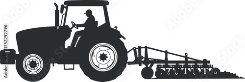 Silhouette of a tractor with a farmer plowing a field in an agricultural setting.