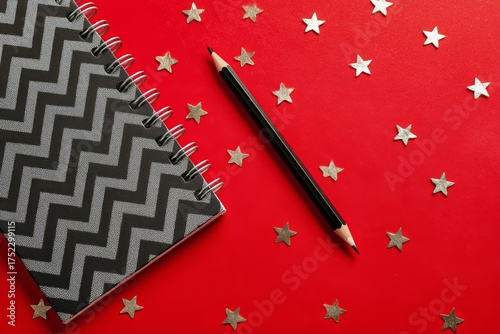 Colorful Notebook With Zigzag Design and Red Pencil on a Starry Background