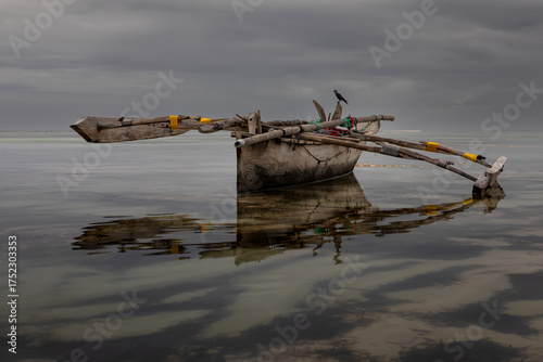 An abandoned ship stands aground. A heavenly landscape. A wooden ship. Beautiful nature. Blue sky.