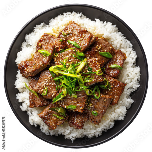 Savory beef cubes atop white rice, garnished with scallions in a black bowl