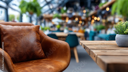 Cozy interior featuring a leather chair and wooden table, surrounded by greenery in a stylish cafe atmosphere.