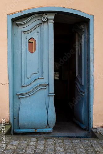 open old blue art nouveau wooden door in an old building in Europe