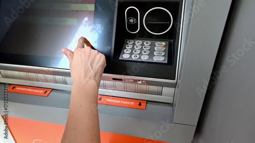 A woman withdrawing or checking money at an ATM