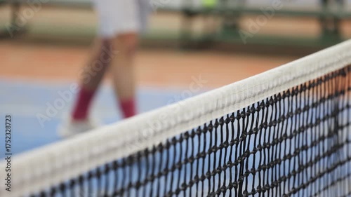 Tennis tournament championship on outdoor clay court with net, professional athletes play in motion with rackets serve tennis ball during tennis match game, tennis training in a sunny day on a stadium