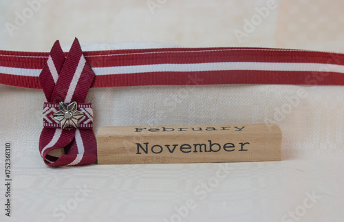 Red-white-red ribbon in the colours of the Latvian national flag. Independence Day in November.