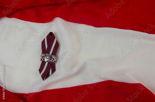 Red-white-red ribbon in the colours of the Latvian national flag. Independence Day in November.