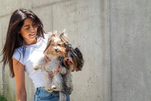 Photography Beautiful woman hugging two Yorkshire terrier dogs outdoor