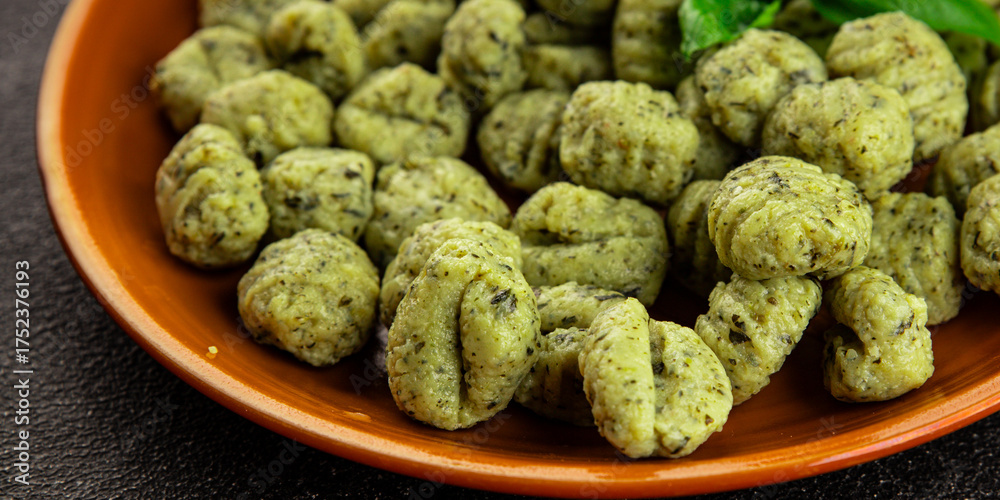 Fototapeta premium Gnocchi spinach potato dough second course portion size natural product tasty snack fresh delicious gourmet food background on the table rustic top view copy space
