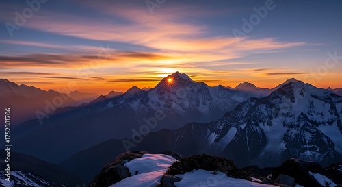 Majestic mountain peak illuminated by the rising sun with colorful sky above