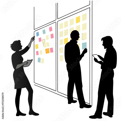 Business team brainstorming and planning on glass wall