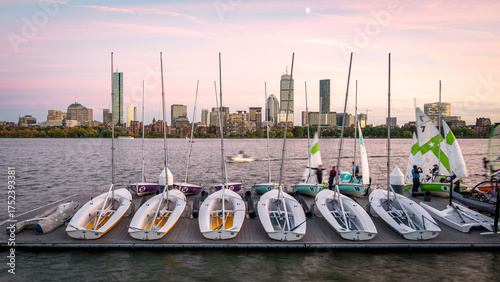 The skyline of Boston in Massachusetts at night as seen from Memorial Driver Road in Cambridge, MA, USA with the famous Charles river in between the two cities.