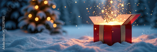 Magical gift box in snowy landscape with glowing sparks around. Beautiful Christmas gift box opens in winter wonderland, surrounded by snow-covered trees and festive lights.