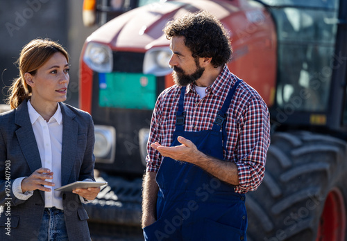 Farmer and woman discuss about business on farm