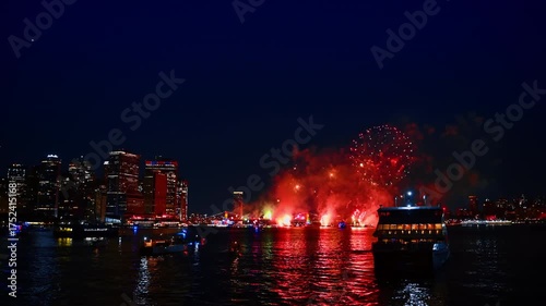 Firework show over the riverscape at night. Beautiful celebration of the 4th July in New York, USA.