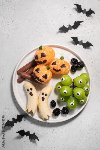 A plate of Halloween themed fruit and vegetables