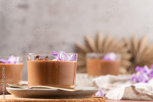 Wallpaper Mural Delicious chocolate mousse in glasses, elegantly garnished with purple flowers and chocolate shavings, a perfect individual sweet treat. Torontodigital.ca