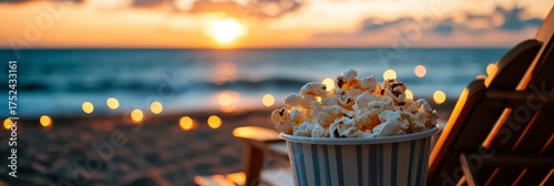 Enjoy movie night with popcorn on a serene beach at sunset. Relax by the ocean, watching a beautiful outdoor film.